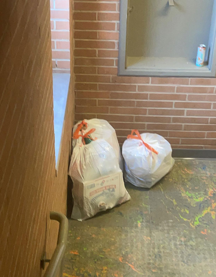 Trash bags left in a stairwell corner, representing lazy-infuriating-people behavior.