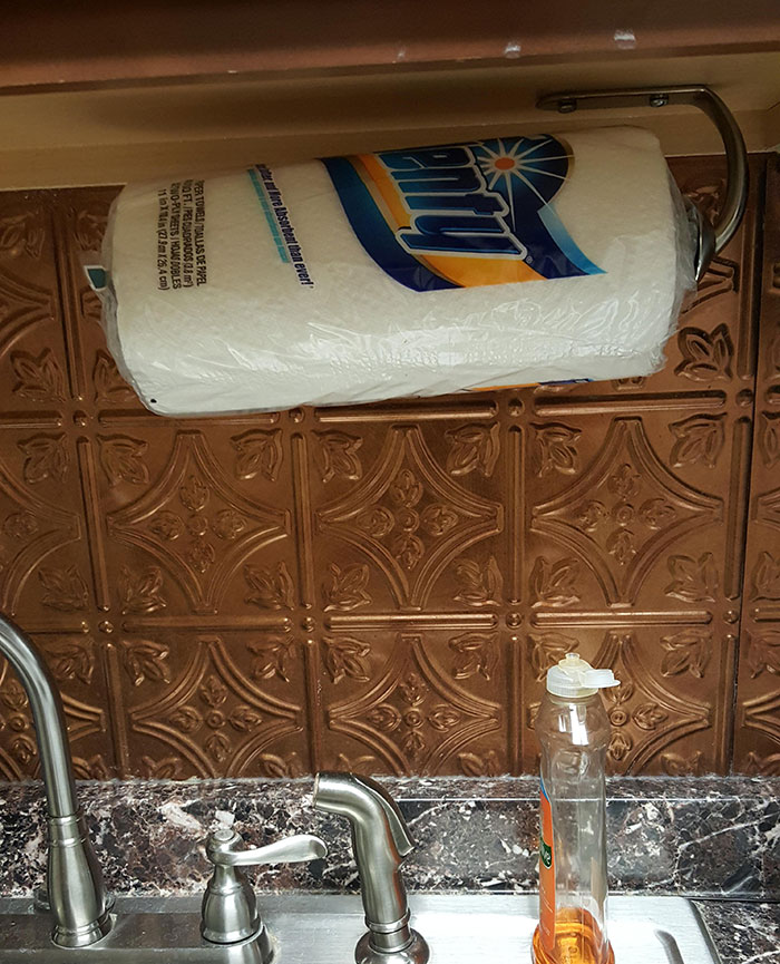 Paper towel roll awkwardly placed above a sink, illustrating lazy-infuriating-people behavior.