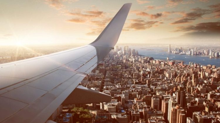 an airplane wing above a city