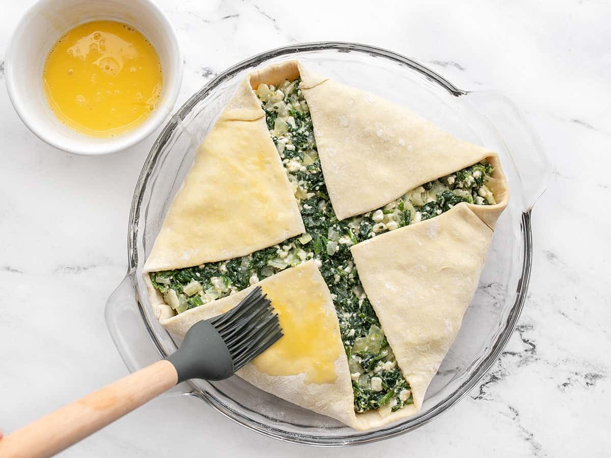 egg being brushed onto puff pastry