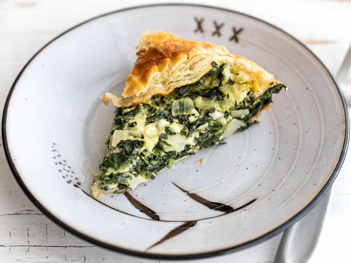 One slice of spinach pie on a plate