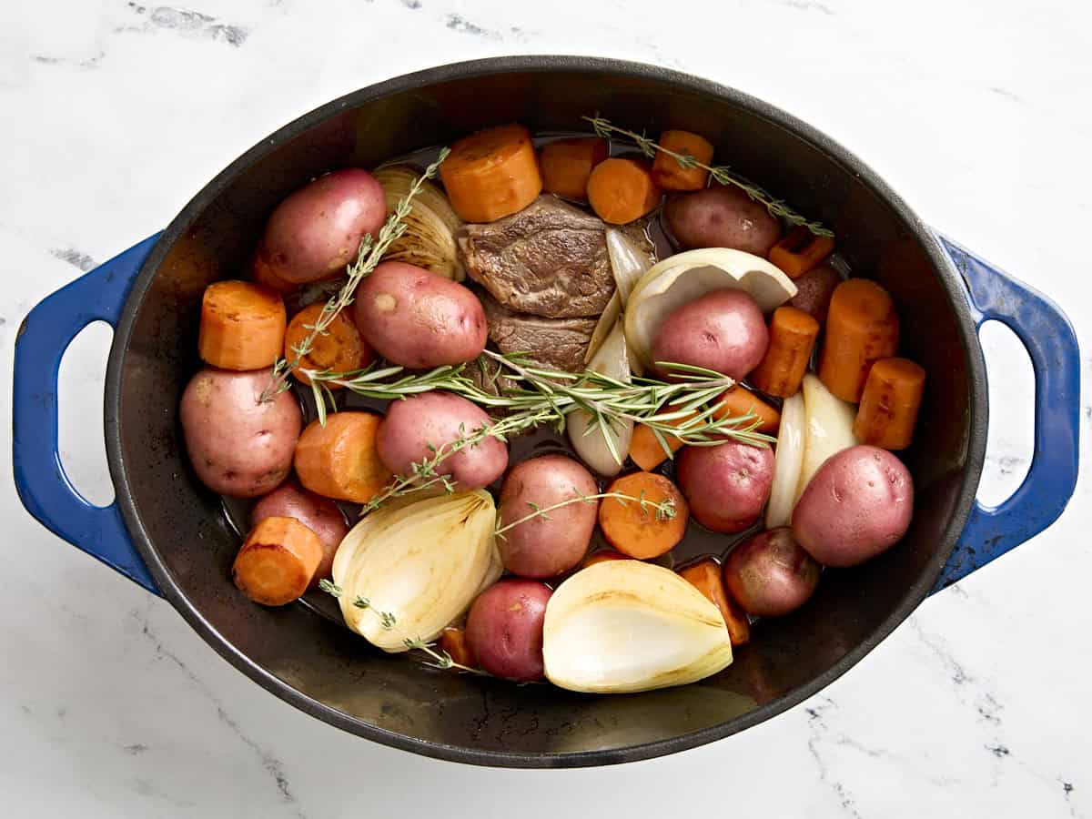 Ingredients added to dutch oven for pot roast.