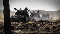 Three self-propelled howitzers of the Bundeswehr (PzH 2000) move into their firing positions