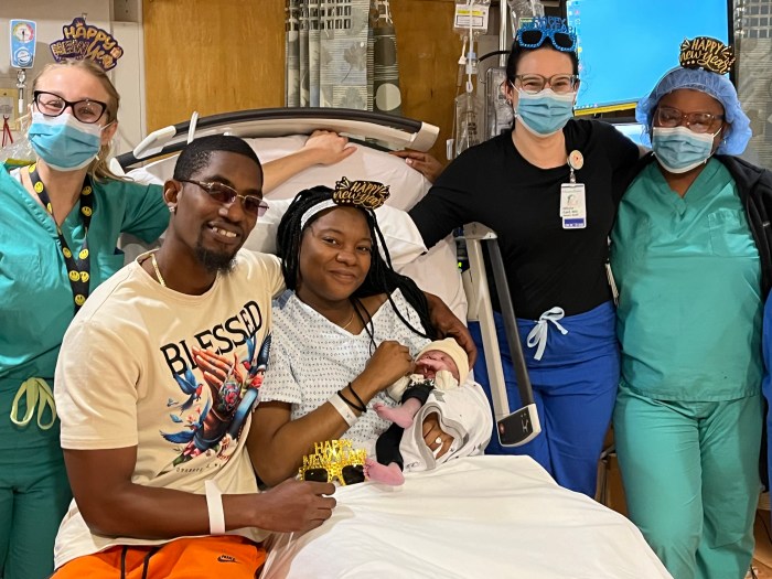 Hospital staff and parents Vanessa McKayhan and Devin Edwards-Williams pose with the first new baby of 2025, Mauryce Edwards-Williams.