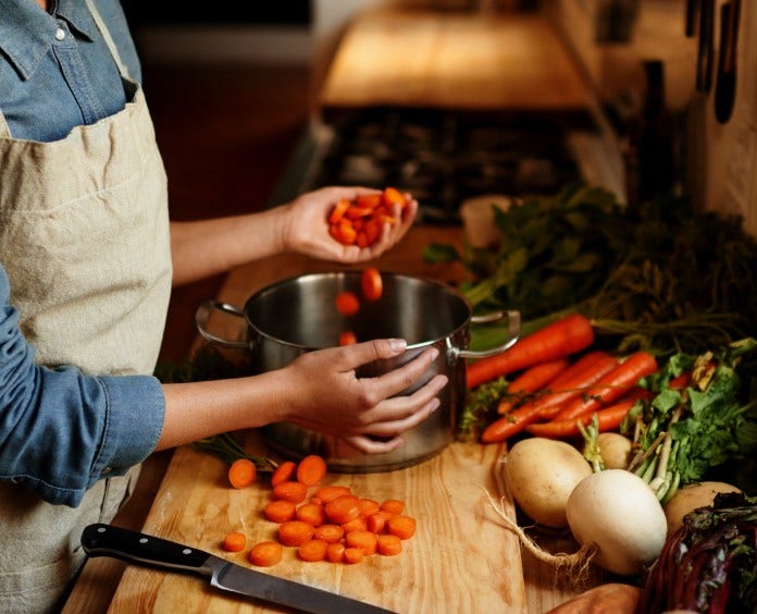 woman chopping vegetables in kitchen