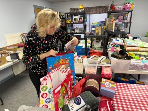 photo of Deb Tanner looking at gifts