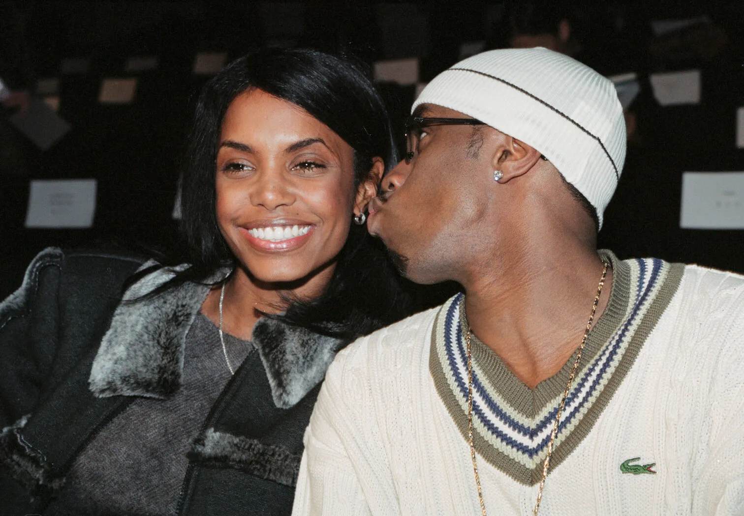 Sean 'Diddy' Combs making a gesture to kiss Kim Porter on the cheek as she smiles