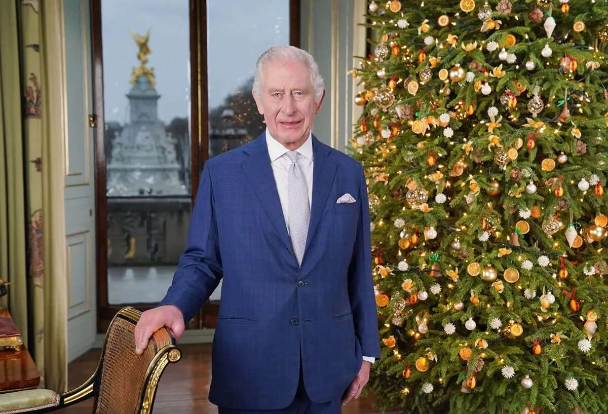 King Charles III poses during the recording of his Christmas message at Buckingham Palace