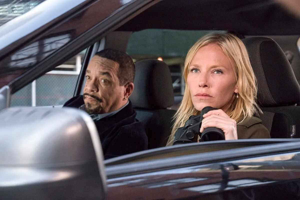 Ice-T and Kelli Giddish sitting in a car in an episode of 'Law & Order SVU'.