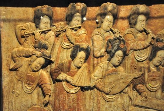 female musicians in a raised-relief from the Five Dynasties and Ten Kingdoms Period displayed at the Capital Museum in Beijing