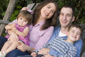 family riding on a swing