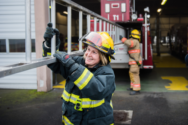 firefighter carrying ladder