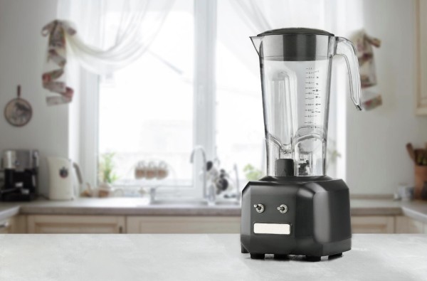 A kitchen with a modern blender on a countertop.