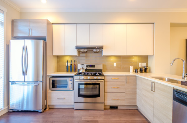 Modern kitchen interior with stainless steel appliances and clean countertops.