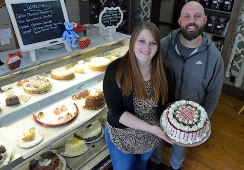 man and woman holding cake