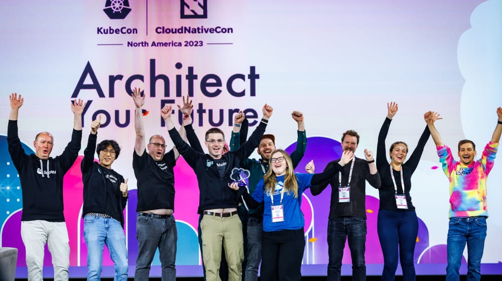 People cheering on a conference stage