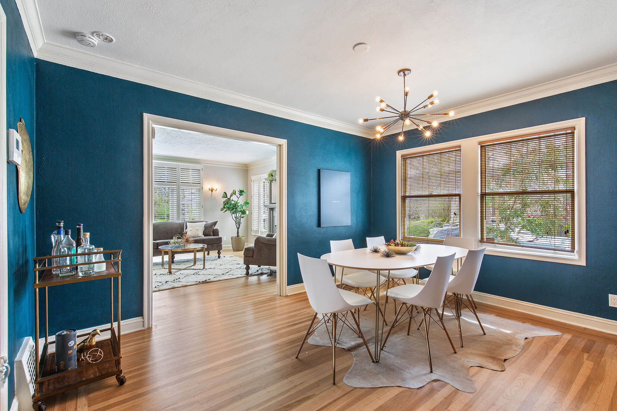 Modern, airy, elegant, newly painted, and staged living room and dining room, after using concierge