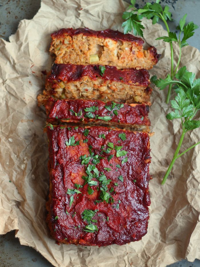 Partially Sliced Vegan Meatloaf Topped with Glaze and Fresh Parsley