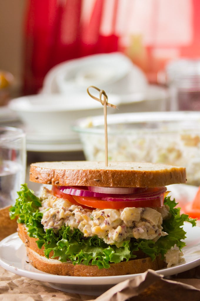 Vegan Tuna Salad Sandwich on a Plate with Dishes in the Background