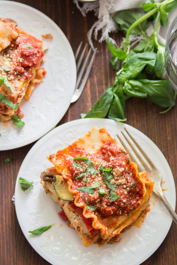 Two Plates of Vegan Lasagna on a Wooden Table