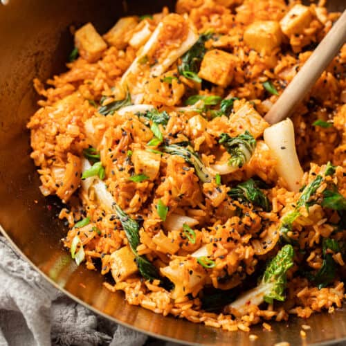 Close up of Vegan Kimchi Fried Rice in a wok with wooden spoon.