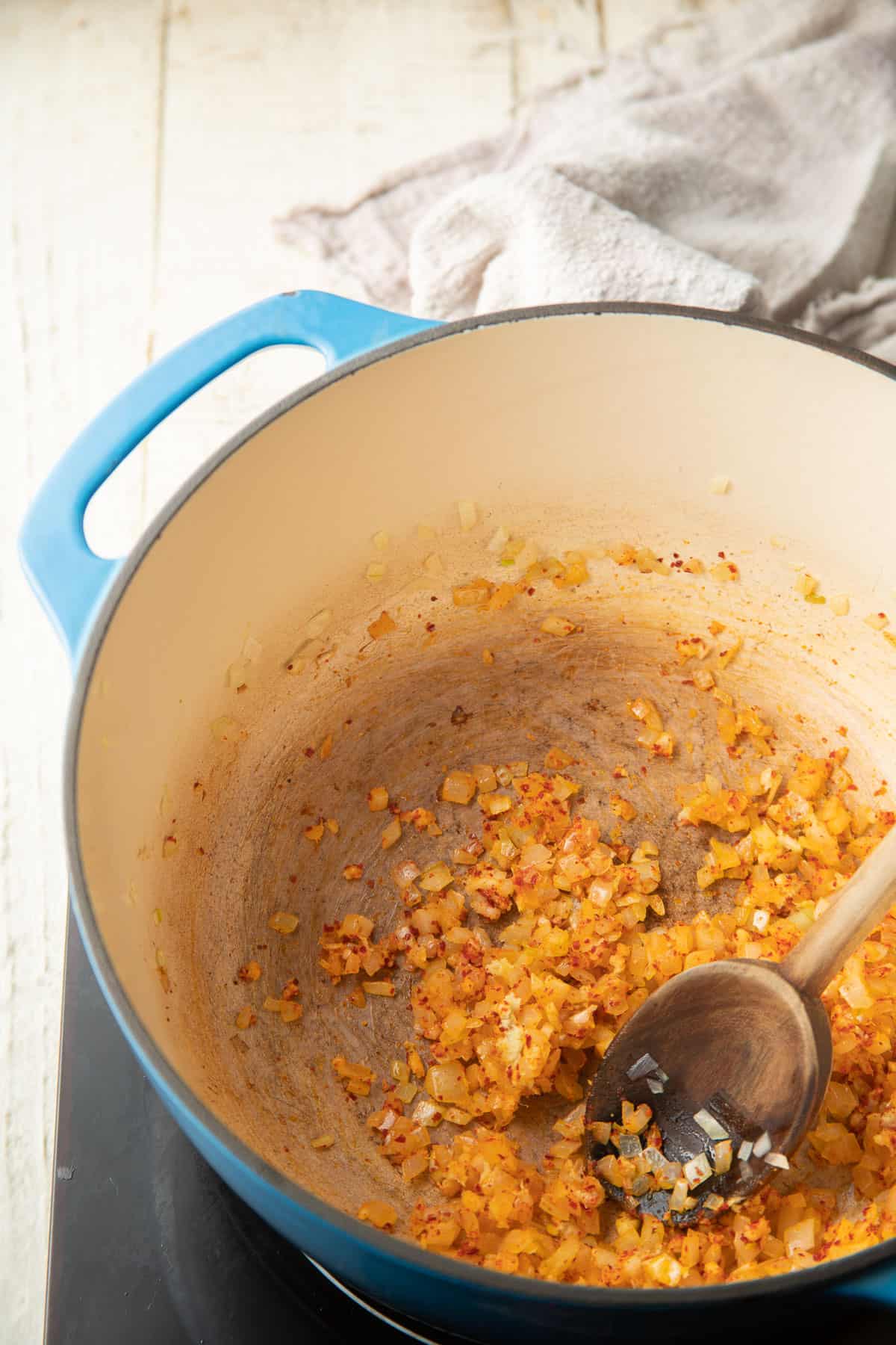 Onions and spices cooking in a pot.