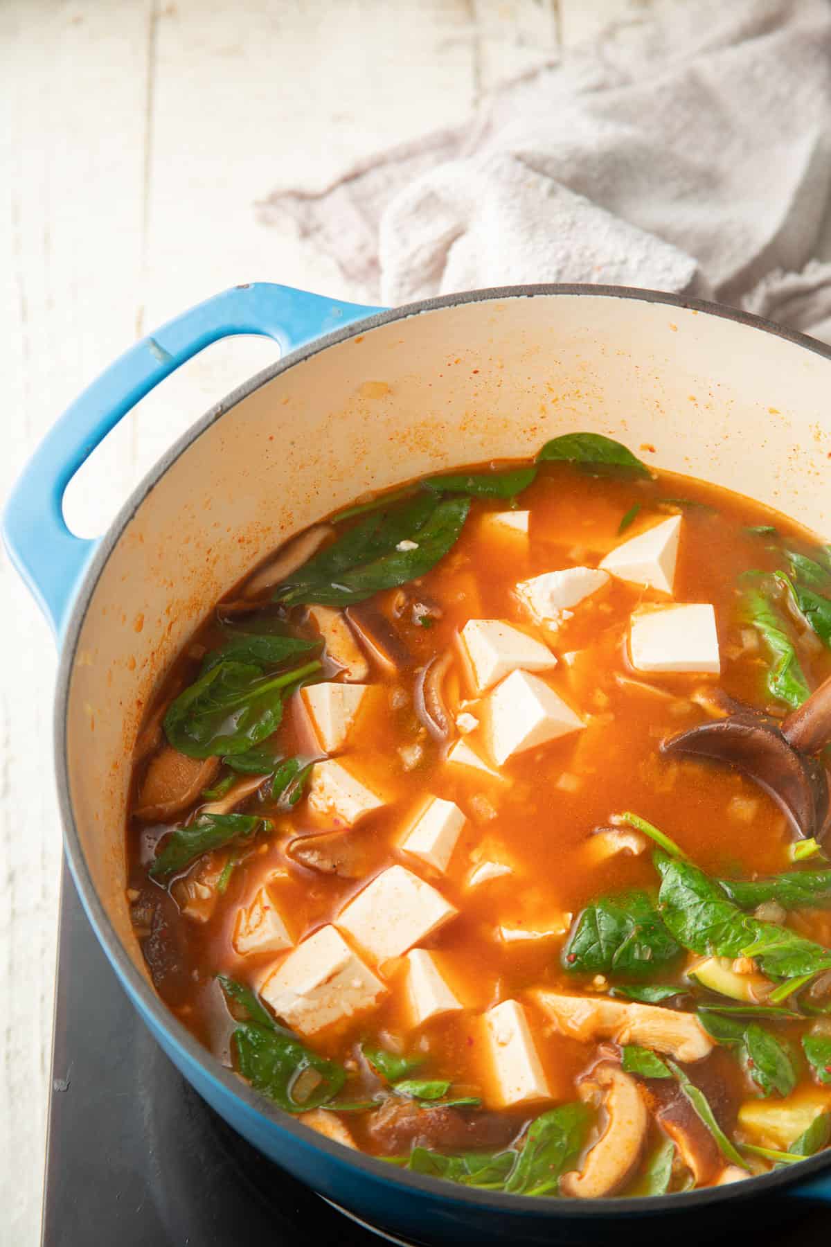 Korean Tofu Soup simmering in a pot.