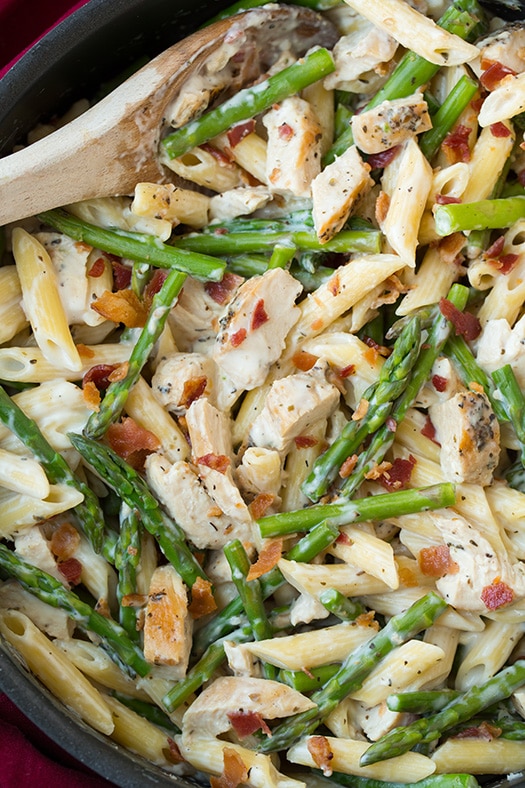 Chicken Asparagus Pasta in skillet with wooden spoon