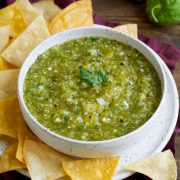 Salsa Verde in a bowl with a side of tortilla chips.