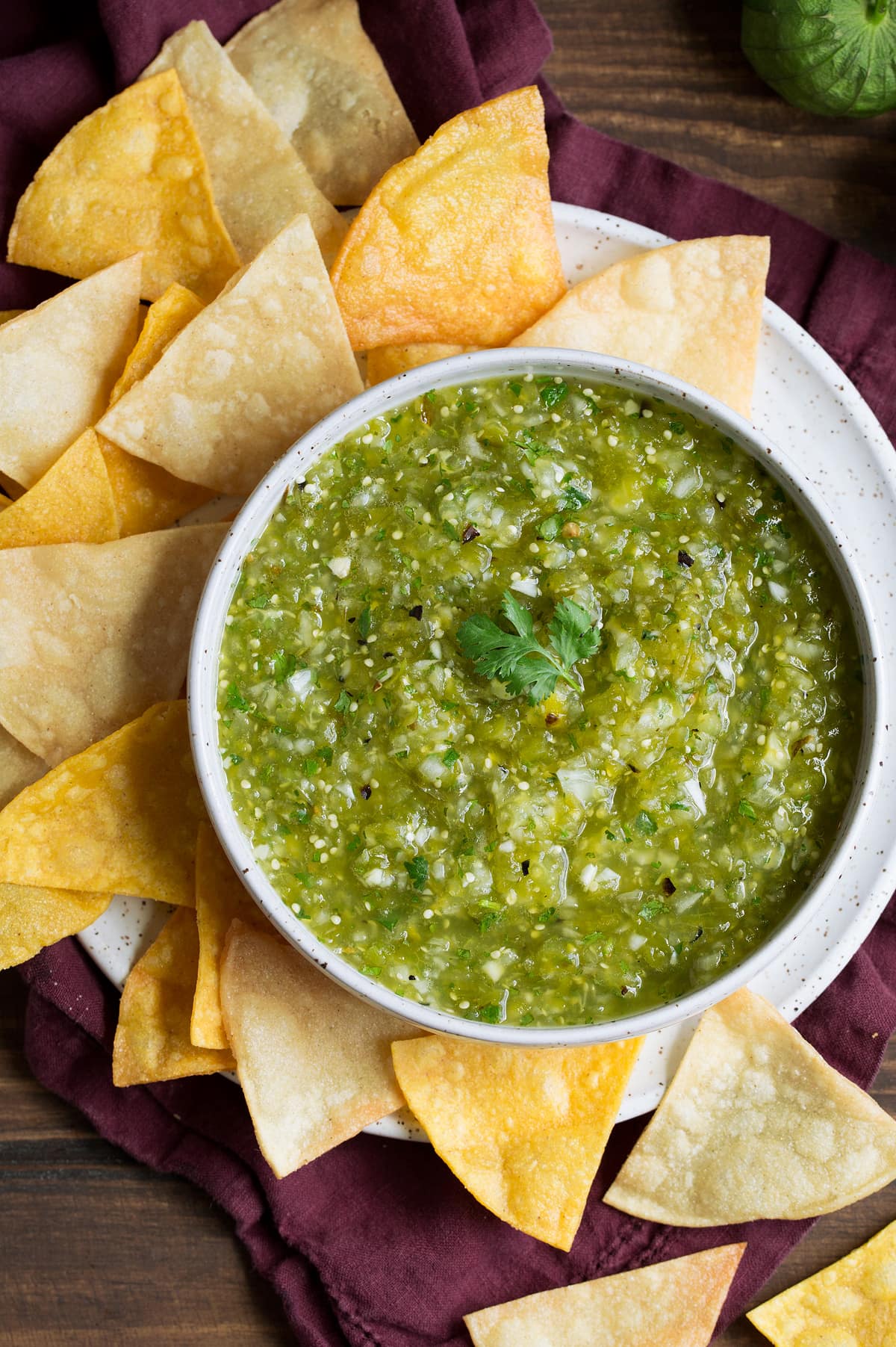 Salsa Verde in a bowl with a side of tortilla chips.