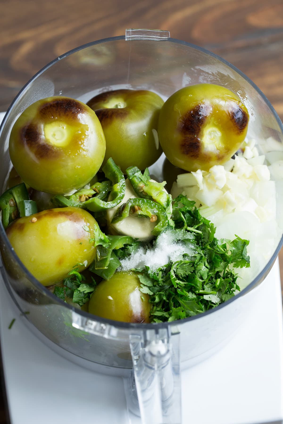 Roasted tomatillos, jalapeno, onion, garlic and cilantro in a food processor.