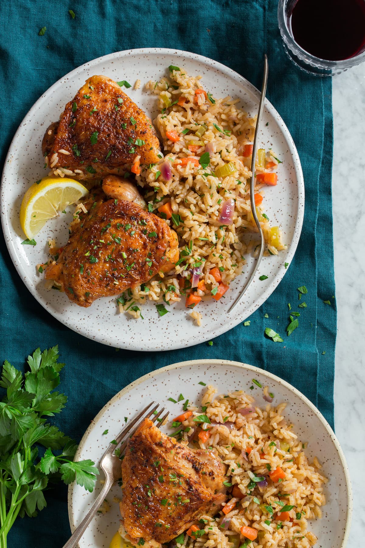 Two plates of chicken and rice. 