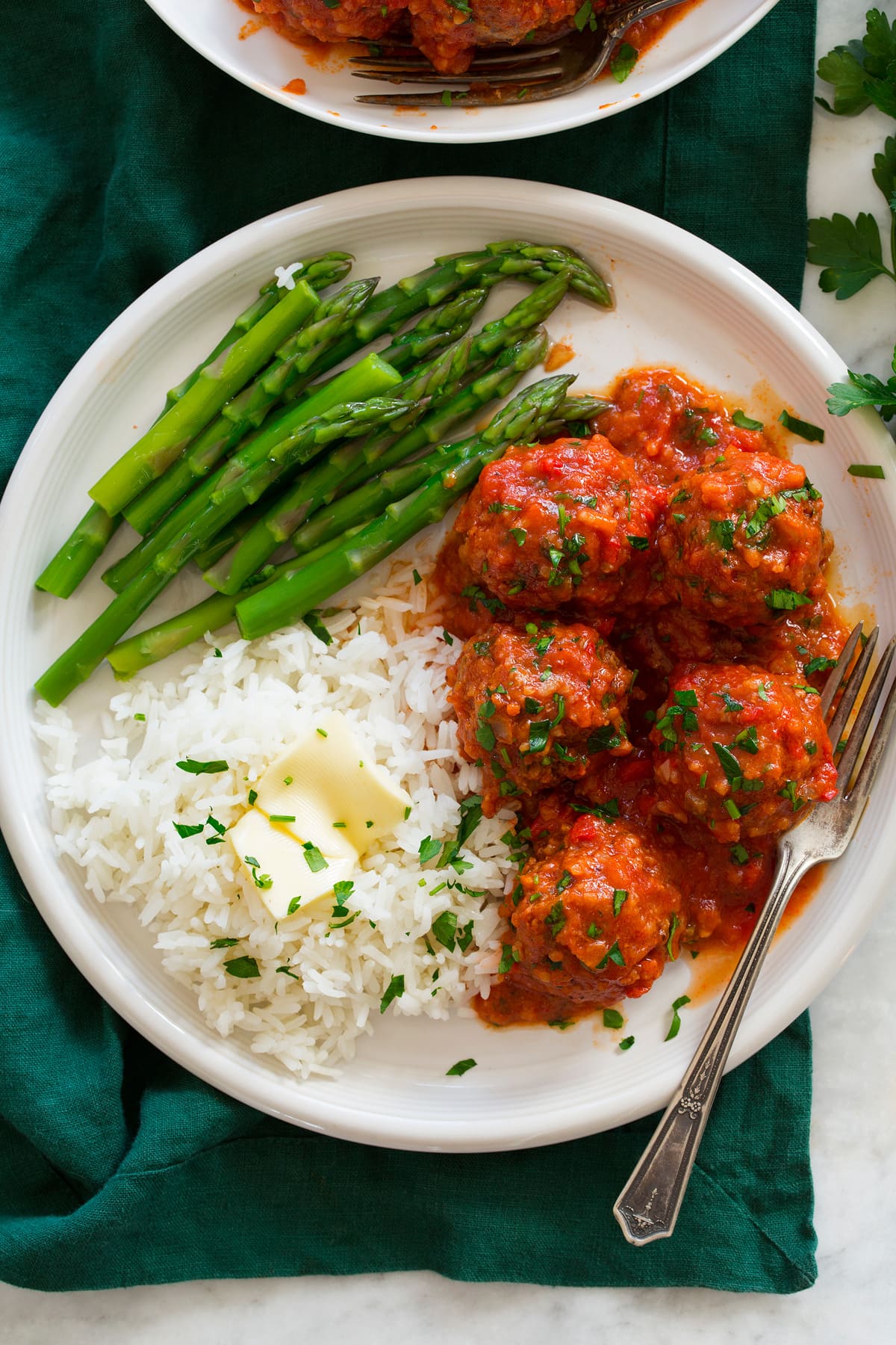 Overhead photo of Porcupine Meatballs meatballs on a plate with rice and asparagus.