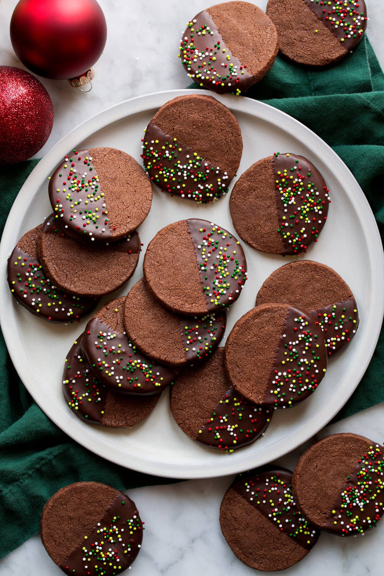 Overhead photo of chocolate dipped chocolate cookies with sprinkles.