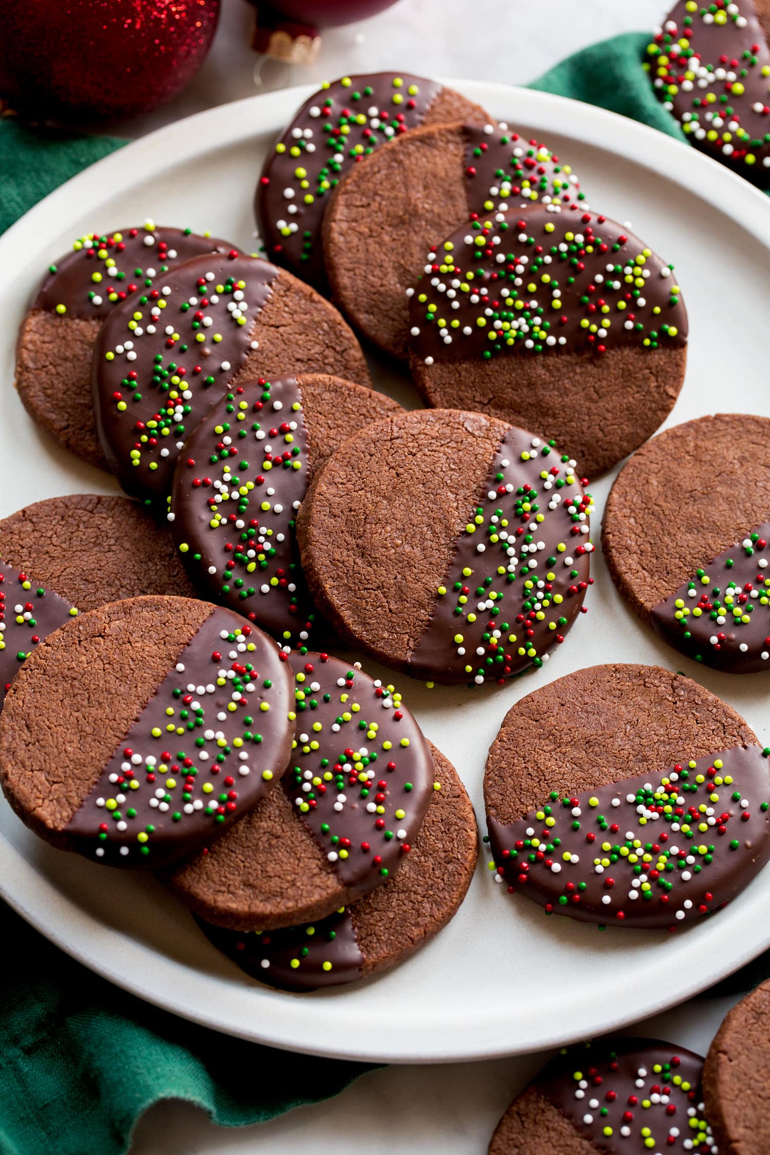 Chocolate Shortbread Cookies coated halfway in chocolate coating and covered with sprinkles.