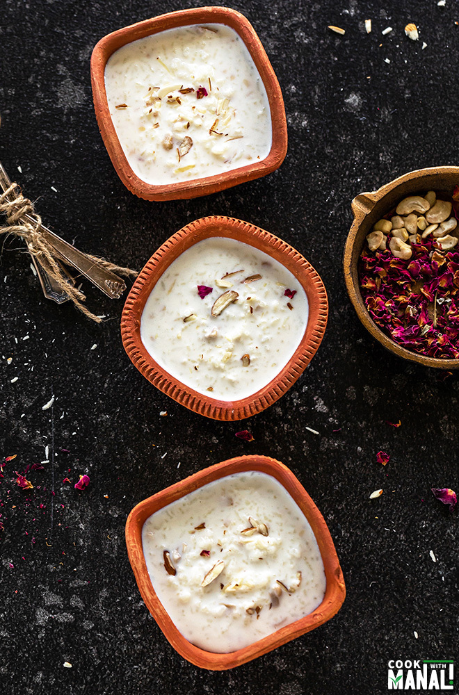 three clay bowls filled with kheer arranged in a straight line