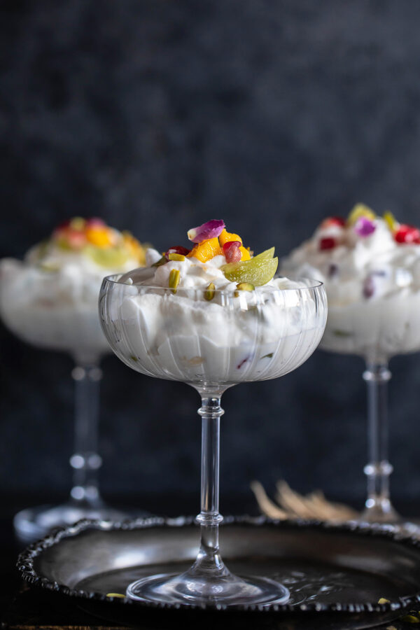 3 glasses filled with whipped cream and fruits