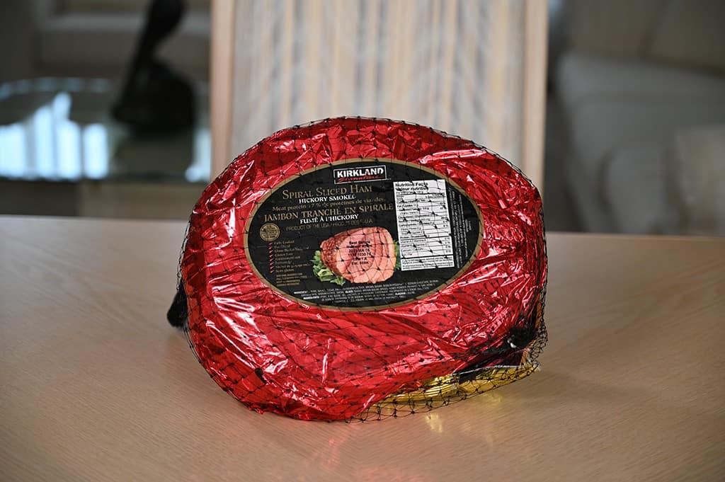 Image of an unopened Kirkland Signature Spiral Ham sitting on a table unopened.