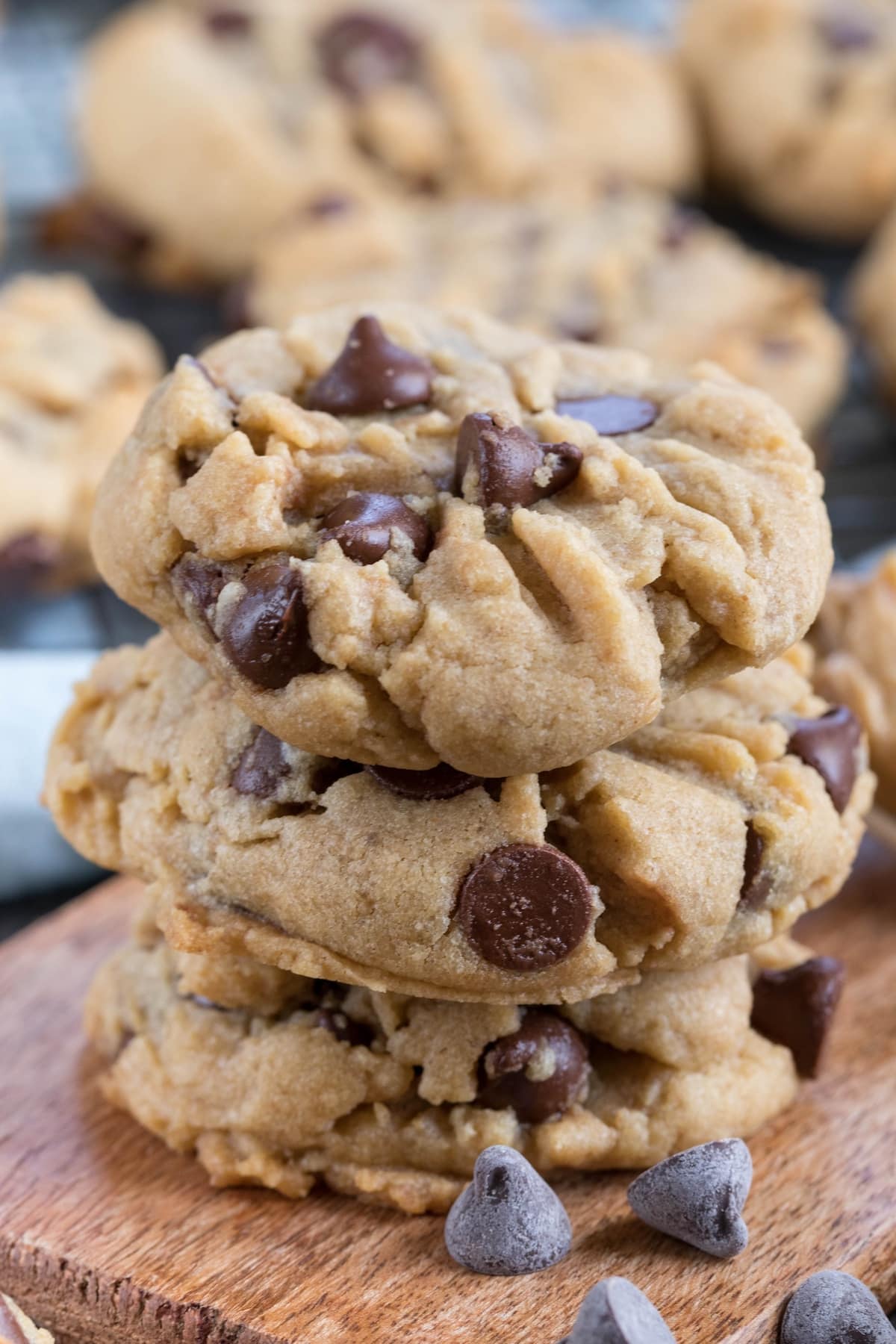 stack of 3 cookies on cutting board.