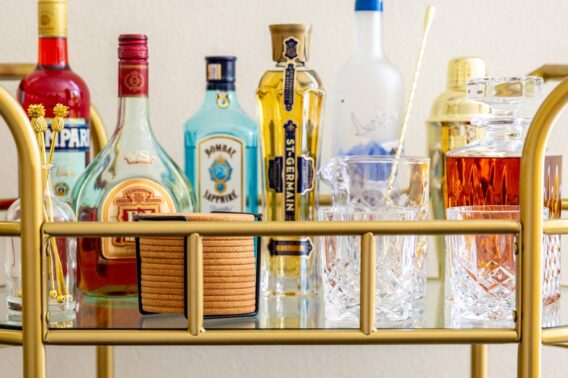 The top tier of a stocked bar cart.