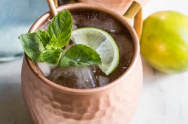 The best Moscow mule in a copper mug with a lime.