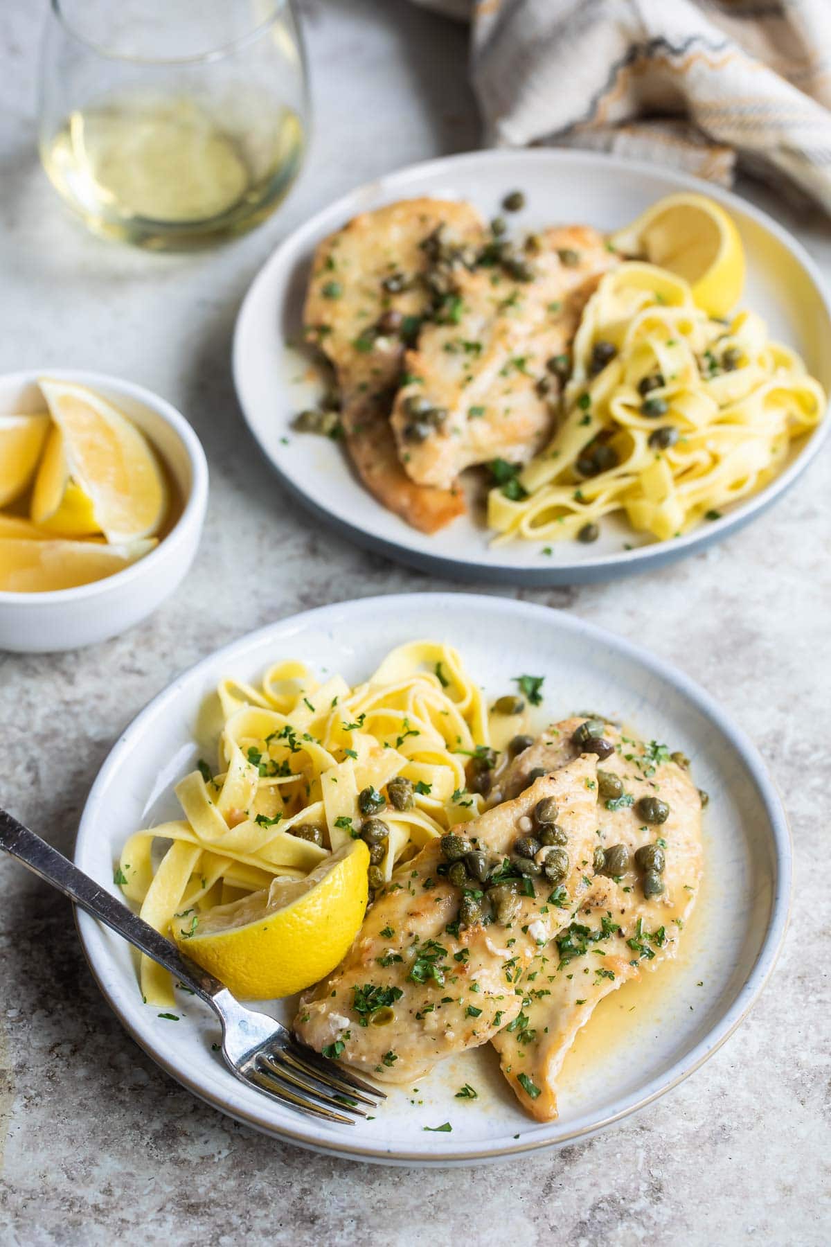 Chicken scallopini on a white plate.