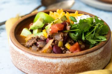 Easy taco soup in a brown bowl.