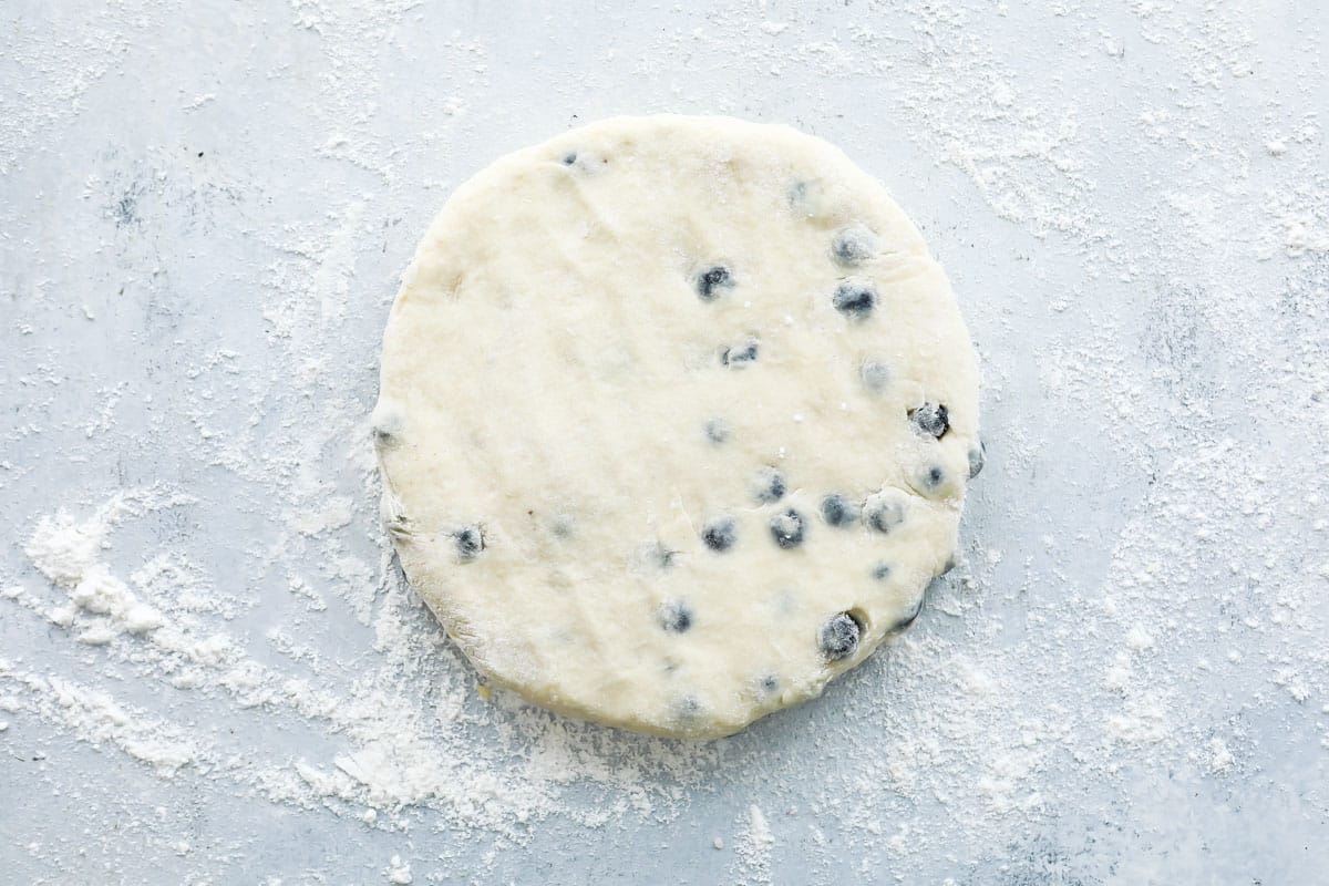 A round piece of blueberry scone dough.