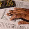 A closeup picture of a 1040 forms on a table with a black pen on it. US tax form. (Chinmayi Shroff/ Getty Images)