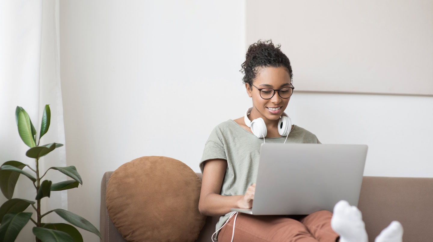 Woman on couch with laptop