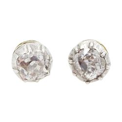 Pair of gold and silver single stone old cut diamond stud earrings, total diamond weight a...