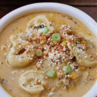 A bowl full of street corn tortellini soup.