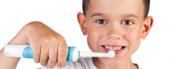 child using an electric toothbrush