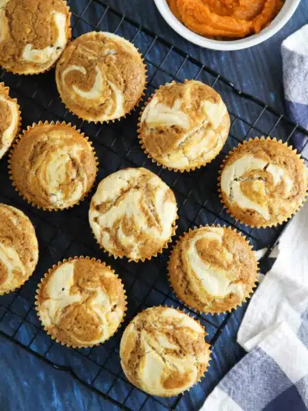 Pumpkin cream cheese muffins are light, fluffy, and moist, full of pumpkin spice flavor, and swirled with creamy cheesecake.